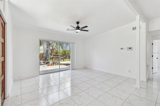 unfurnished room with visible vents, a ceiling fan, and marble finish floor