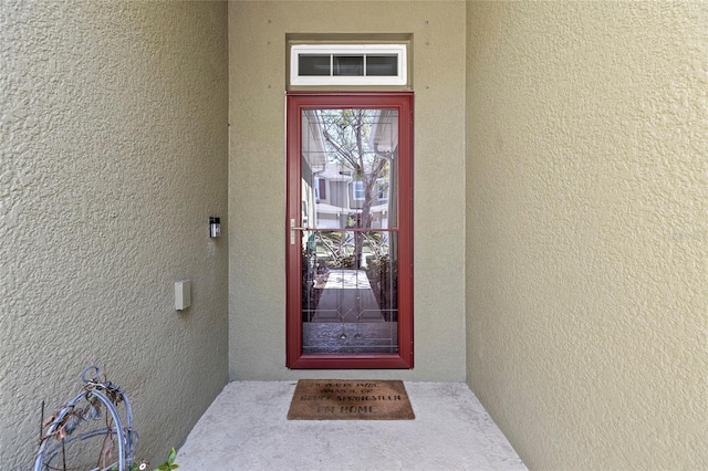 entrance to property with stucco siding