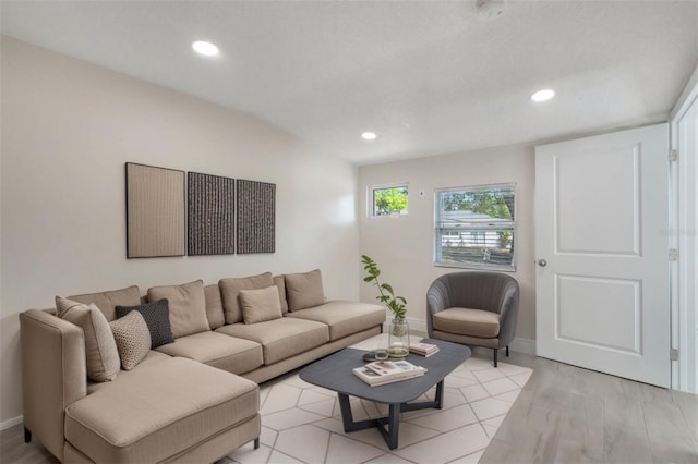 living room featuring light wood finished floors, recessed lighting, and baseboards