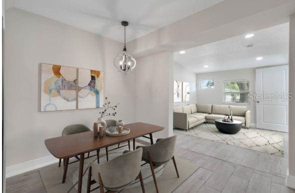 dining space featuring an inviting chandelier, recessed lighting, and baseboards