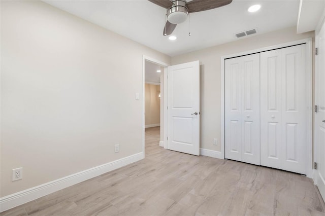 unfurnished bedroom with visible vents, a ceiling fan, a closet, light wood-style floors, and baseboards