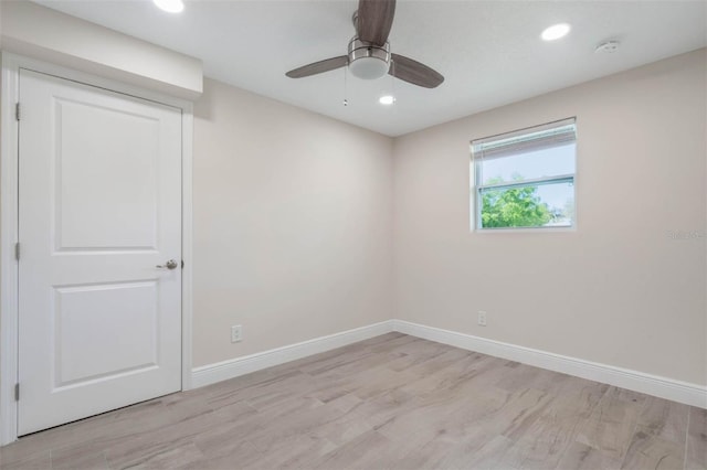 empty room with a ceiling fan, recessed lighting, baseboards, and light wood finished floors