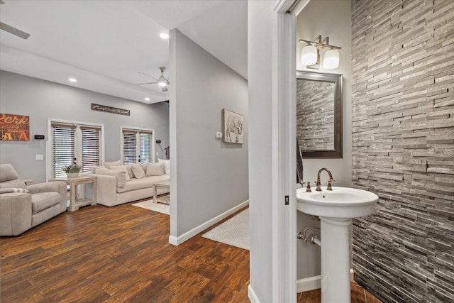 bathroom featuring baseboards, recessed lighting, wood finished floors, a ceiling fan, and a sink