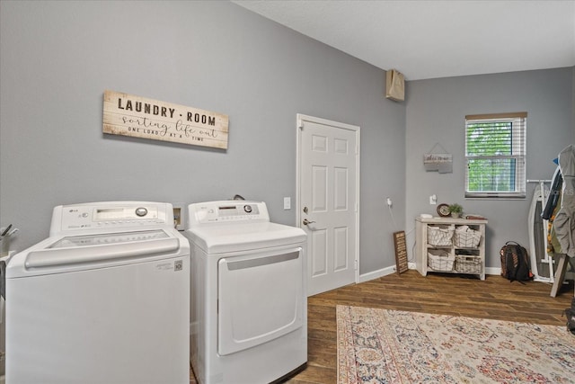 clothes washing area with laundry area, wood finished floors, separate washer and dryer, and baseboards