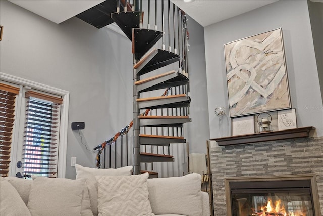 stairway with a stone fireplace