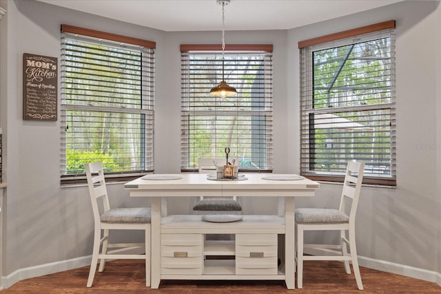 dining area featuring wood finished floors and baseboards