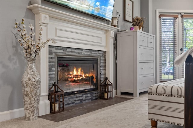 interior details featuring a fireplace and baseboards