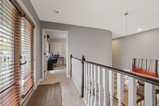 hall featuring recessed lighting, baseboards, carpet floors, and an upstairs landing