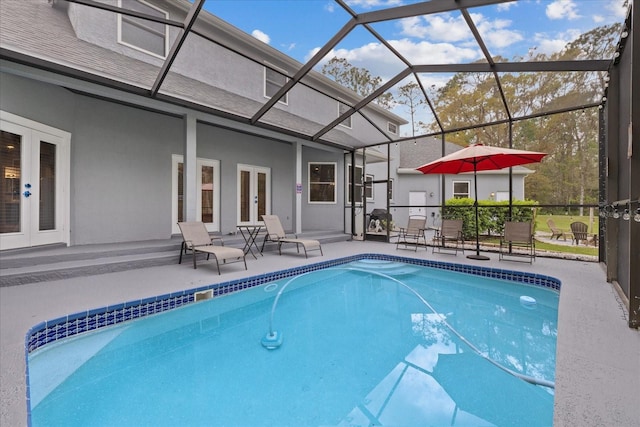 pool with french doors, a lanai, and a patio area