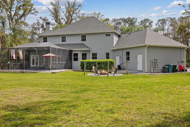 back of house with stucco siding, a yard, a fire pit, a lanai, and a chimney