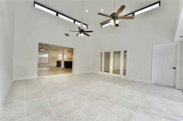 unfurnished living room featuring light tile patterned floors, visible vents, french doors, and baseboards