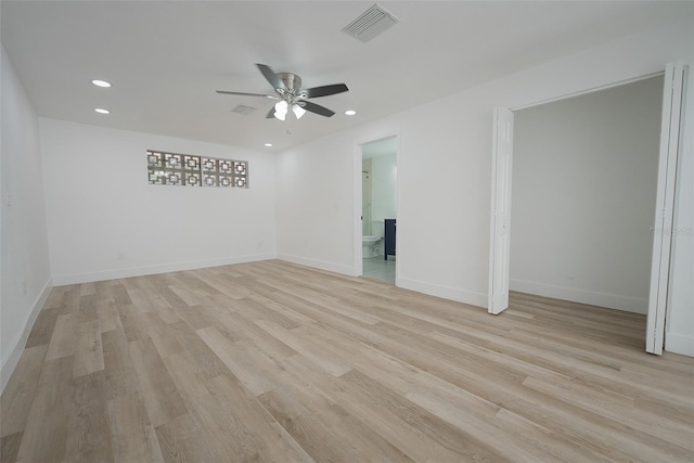 empty room with light wood-style flooring, recessed lighting, visible vents, and baseboards