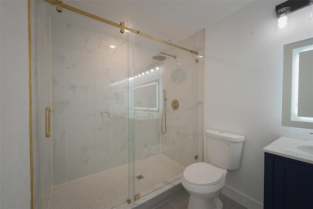 full bath with toilet, a marble finish shower, baseboards, vanity, and a textured wall