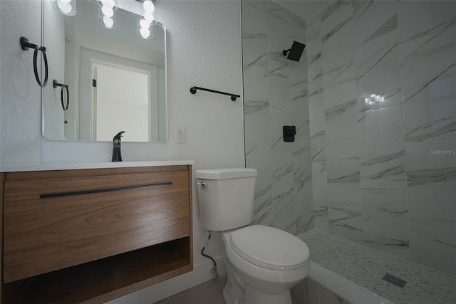 full bath featuring vanity, toilet, and a marble finish shower