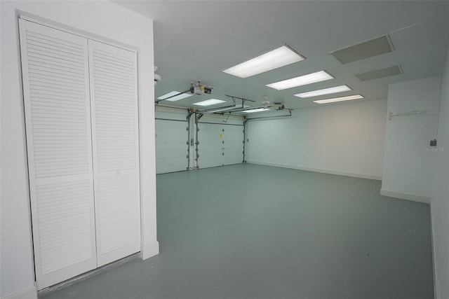 garage featuring a garage door opener and baseboards