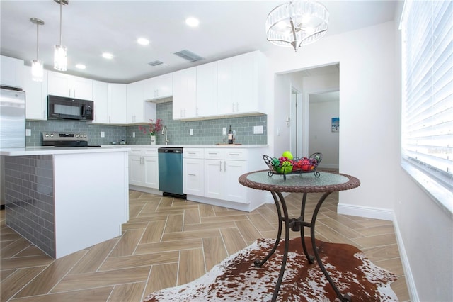 kitchen with tasteful backsplash, stainless steel appliances, light countertops, and baseboards