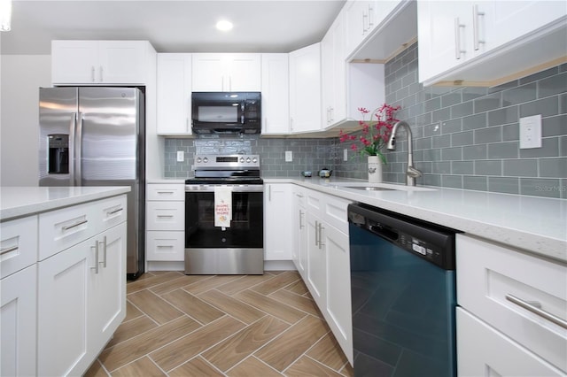 1902 Andover St Unit 198, Sun City Center, FL 33573 - kitchen featuring stainless steel appliances, a sink, decorative backsplash, white cabinetry, and recessed lighting