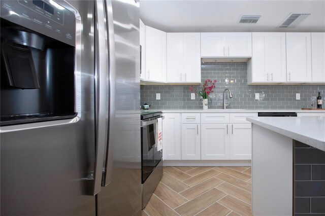 1902 Andover St Unit 198, Sun City Center, FL 33573 - kitchen featuring freestanding refrigerator, a sink, and white cabinetry