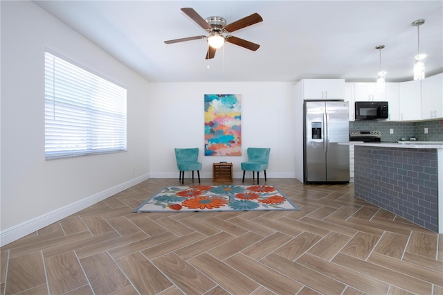 1902 Andover St Unit 198, Sun City Center, FL 33573 - kitchen featuring appliances with stainless steel finishes, baseboards, a ceiling fan, light countertops, and white cabinets