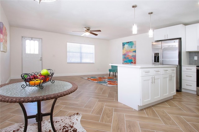 1902 Andover St Unit 198, Sun City Center, FL 33573 - kitchen featuring ceiling fan, light countertops, baseboards, and healthy amount of natural light