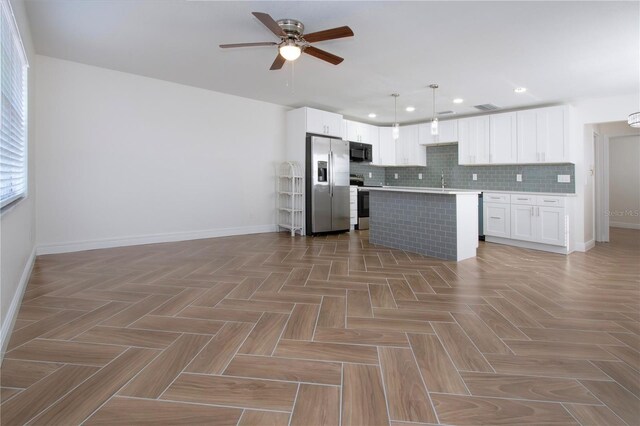 1902 Andover St Unit 198, Sun City Center, FL 33573 - kitchen with stainless steel appliances, baseboards, ceiling fan, open floor plan, and tasteful backsplash