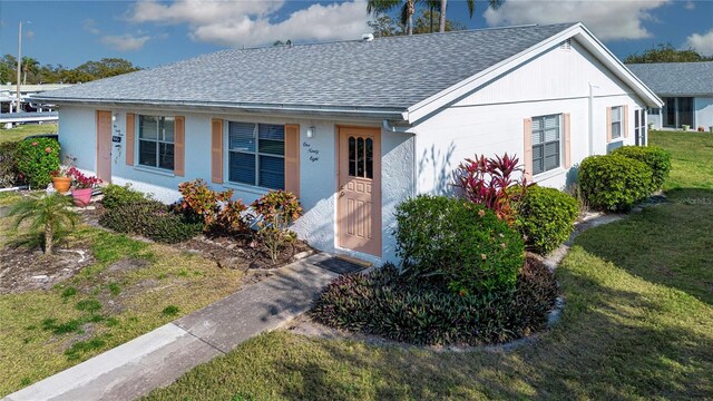 1902 Andover St Unit 198, Sun City Center, FL 33573 - ranch-style home featuring roof with shingles and a front lawn