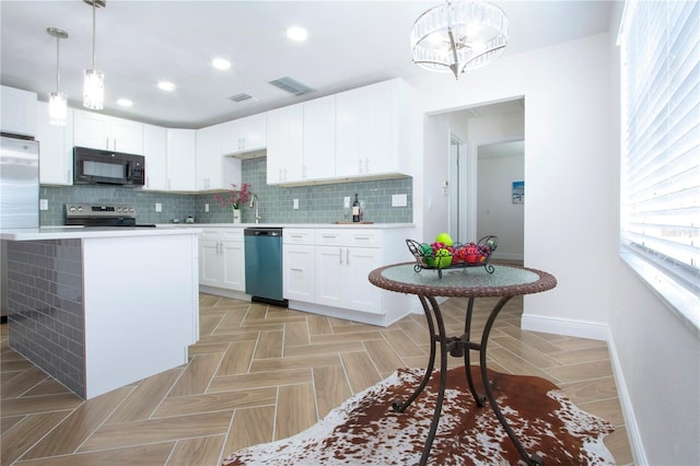 1902 Andover St Unit 198, Sun City Center, FL 33573 - kitchen with stainless steel appliances, baseboards, light countertops, backsplash, and white cabinets
