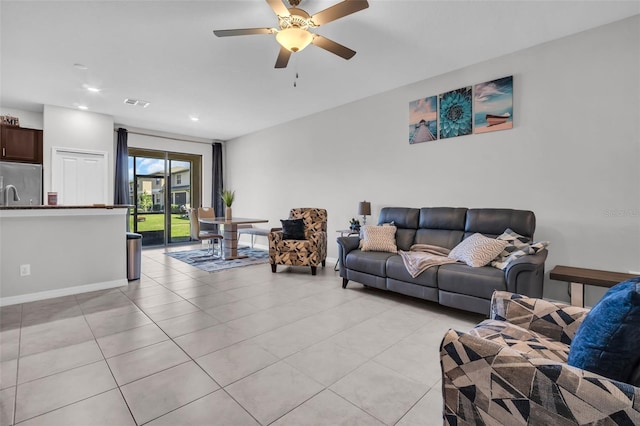 living area featuring a ceiling fan, visible vents, baseboards, light tile patterned flooring, and recessed lighting