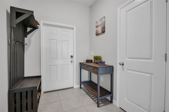 interior space featuring light tile patterned floors and baseboards