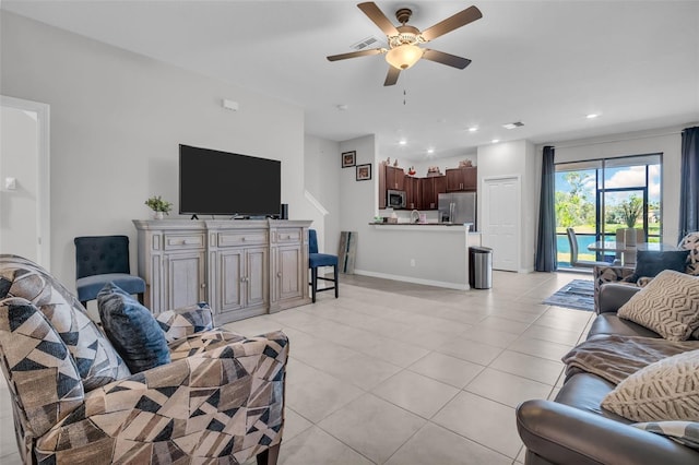 living area with visible vents, recessed lighting, light tile patterned floors, baseboards, and ceiling fan