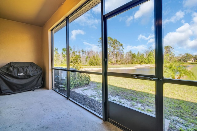 unfurnished sunroom with a water view