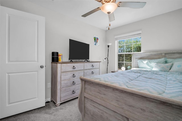 bedroom with light carpet and a ceiling fan