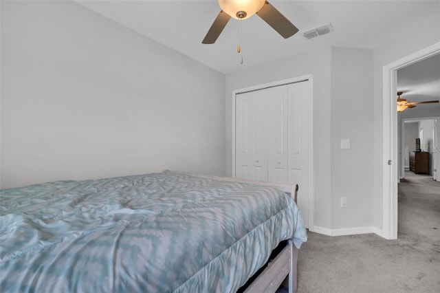 carpeted bedroom featuring a ceiling fan, baseboards, visible vents, and a closet