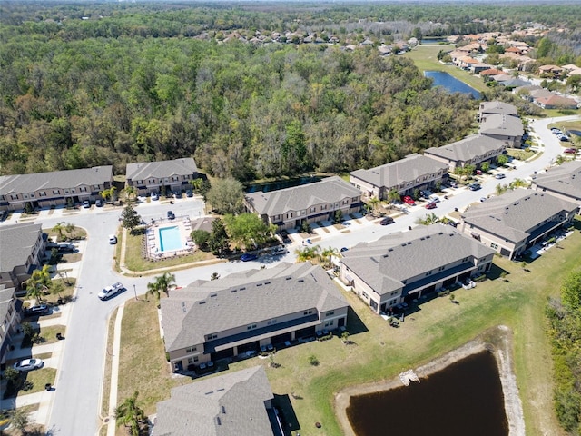 birds eye view of property with a residential view, a forest view, and a water view