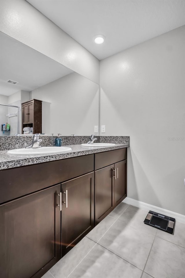 8512 Reedville St, New Port Richey, FL 34654 - full bath featuring double vanity, baseboards, tile patterned floors, and a shower stall