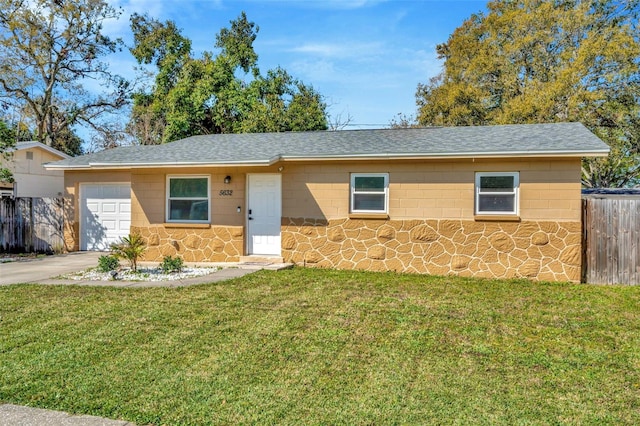 single story home featuring a front yard, an attached garage, fence, and a shingled roof