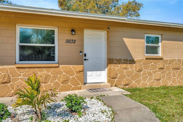 property entrance featuring stone siding