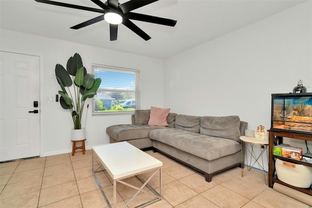 living room featuring light tile patterned floors, baseboards, and ceiling fan