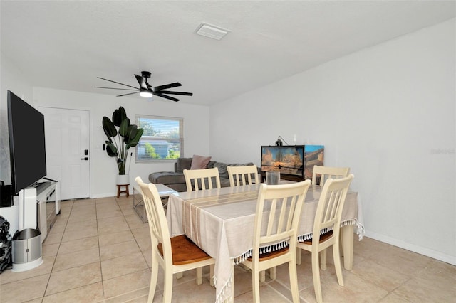 dining area with light tile patterned flooring, baseboards, visible vents, and ceiling fan