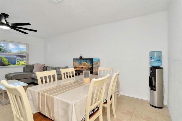 dining area with light tile patterned floors, baseboards, and ceiling fan