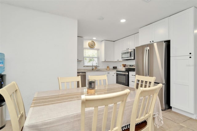 dining space with light tile patterned floors and recessed lighting