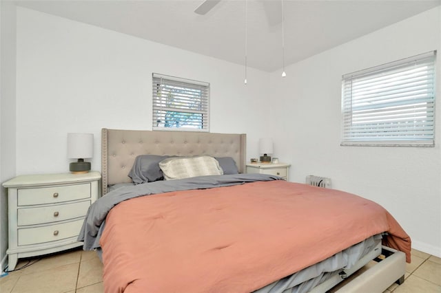 bedroom with radiator, light tile patterned floors, and ceiling fan