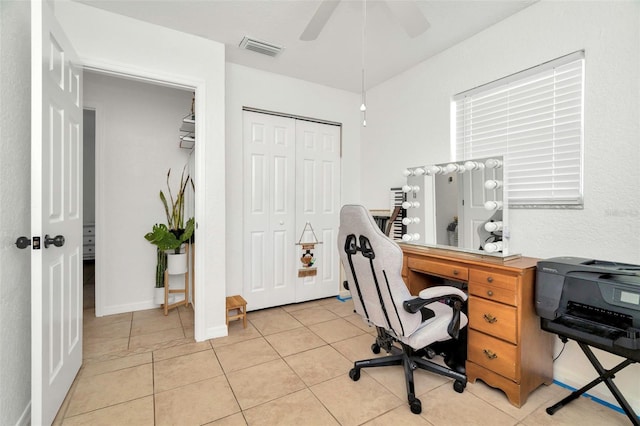 office with light tile patterned floors, baseboards, visible vents, and ceiling fan