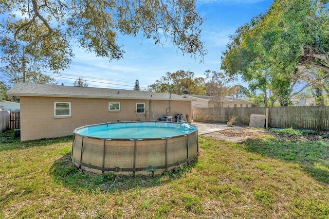 exterior space with a yard, a fenced in pool, and a fenced backyard