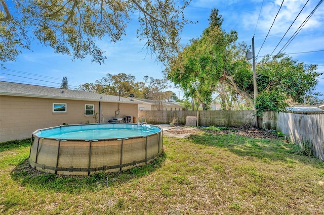 view of yard with a fenced in pool and a fenced backyard