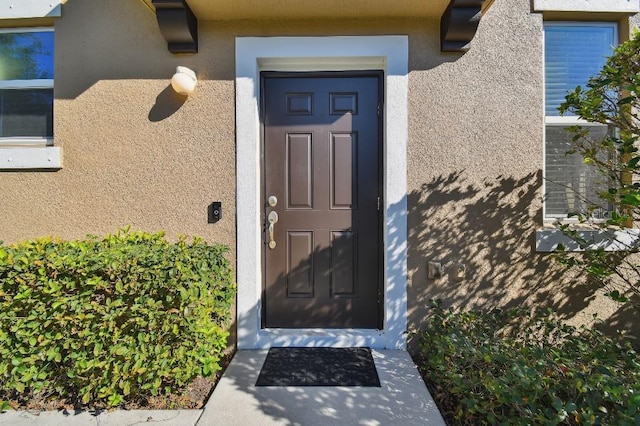 view of exterior entry with stucco siding