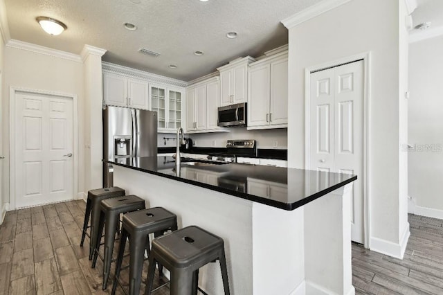 kitchen featuring a sink, visible vents, dark countertops, and appliances with stainless steel finishes