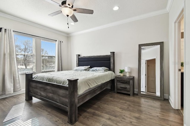 bedroom featuring ceiling fan, baseboards, dark wood-style floors, and crown molding