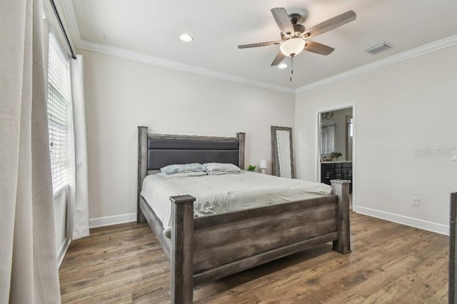 bedroom with baseboards, wood finished floors, visible vents, and ornamental molding