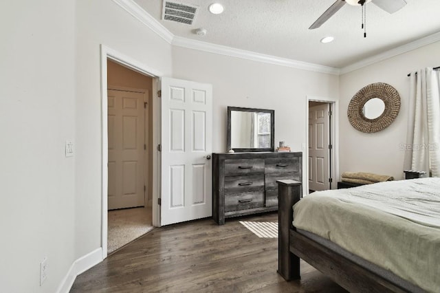 bedroom featuring visible vents, baseboards, dark wood-style floors, and crown molding